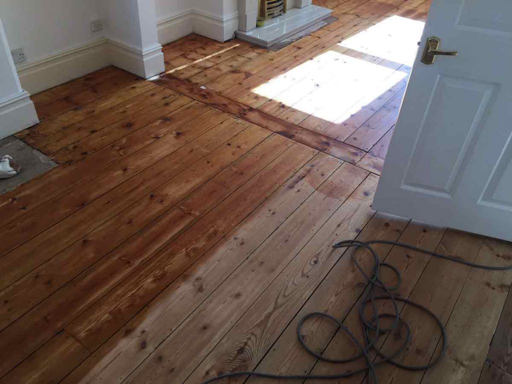 During wood floor sanding and oil finishing in Exeter home