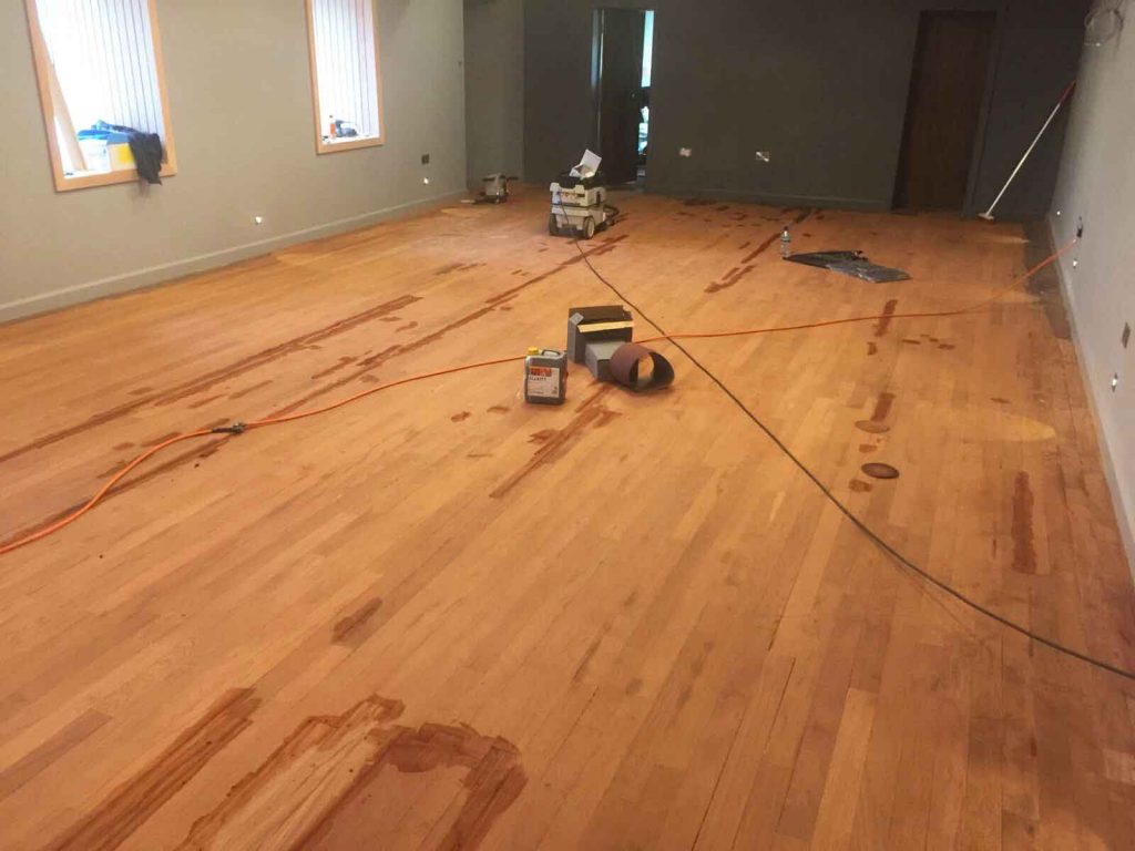 Preparing and sanding the wooden floor at Exeter Golf and Country Club