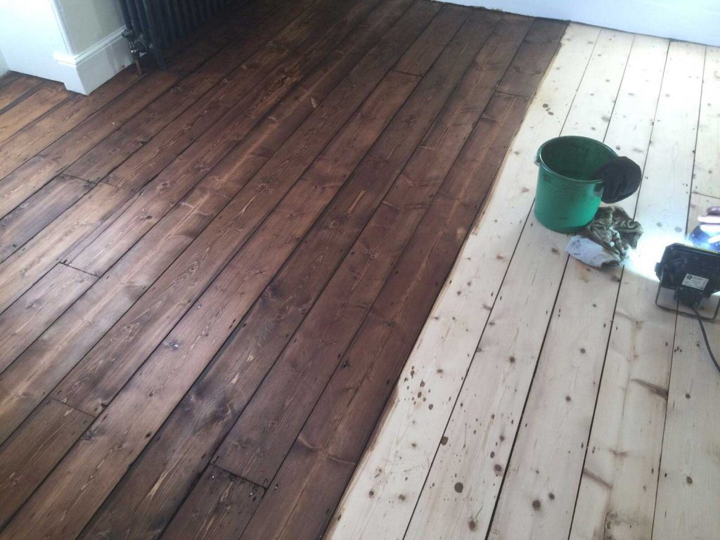 See the sanded wooden floor boards and those stained with a Dark Oak Staining