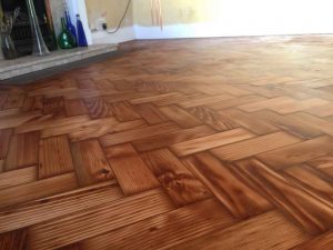 Herringbone wooden floor once it has received two coats of oil after wood floor repairs