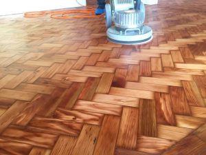 Herringbone wooden floor receives two coats of oil
