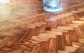 Herringbone wooden floor receives two coats of oil